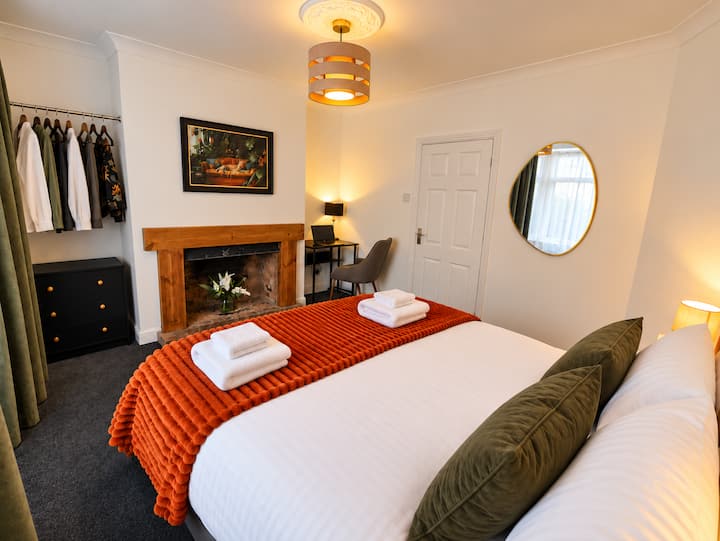 King size bed, usb sockets, hangers, draws, bed side tables, lights, mirror,  blanket, fireplace , work station, bedding, pillows, cushions.