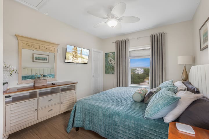 Wake up to the Fort Morgan dunes in the window and take your time: king bed, your own TV, and a full dresser so you can actually unpack.