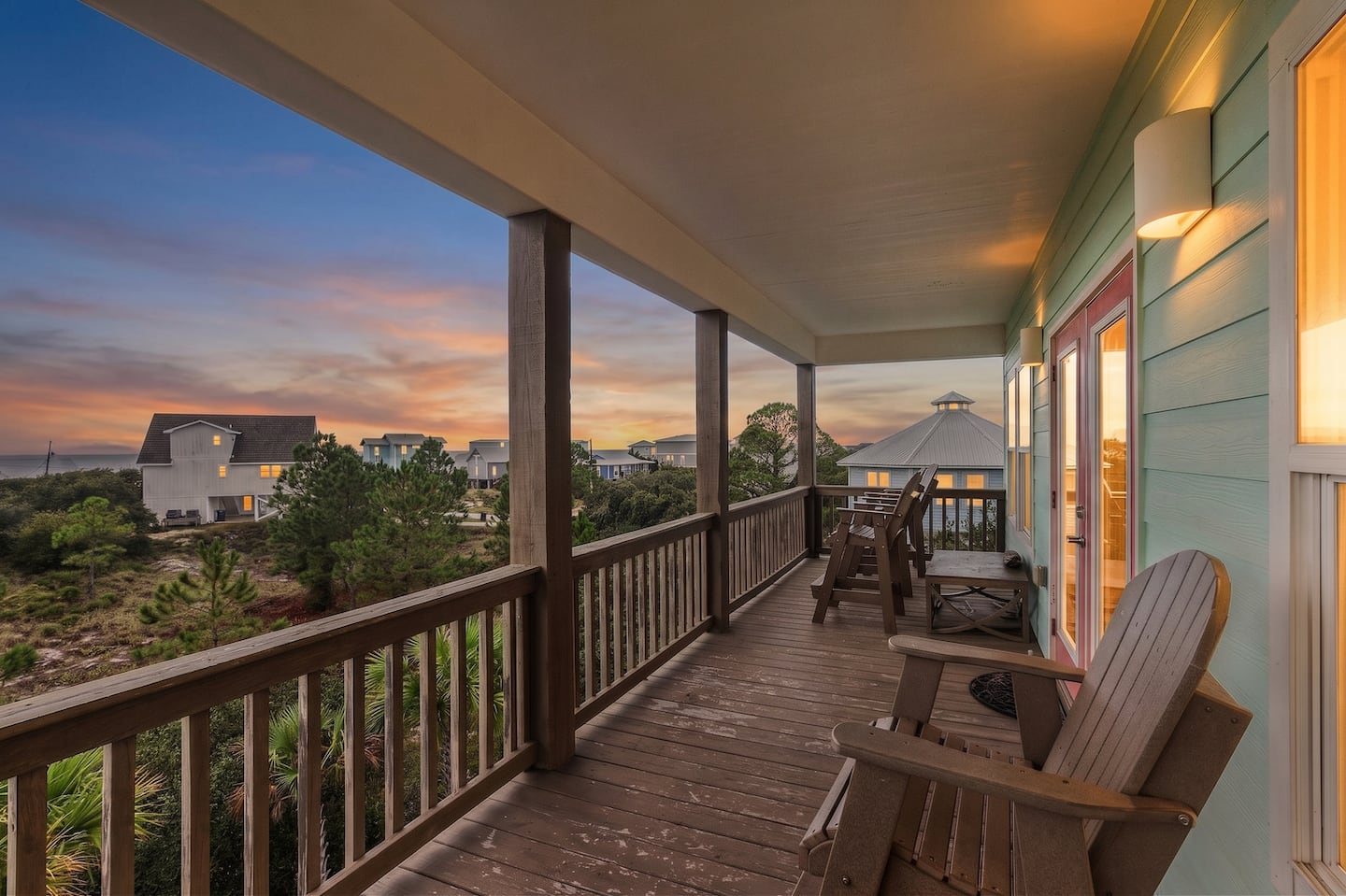 Carry your drink out to the covered deck as the sun drops behind the rooftops: porch lights on, warm air off the Gulf, and nowhere else you need to be.
