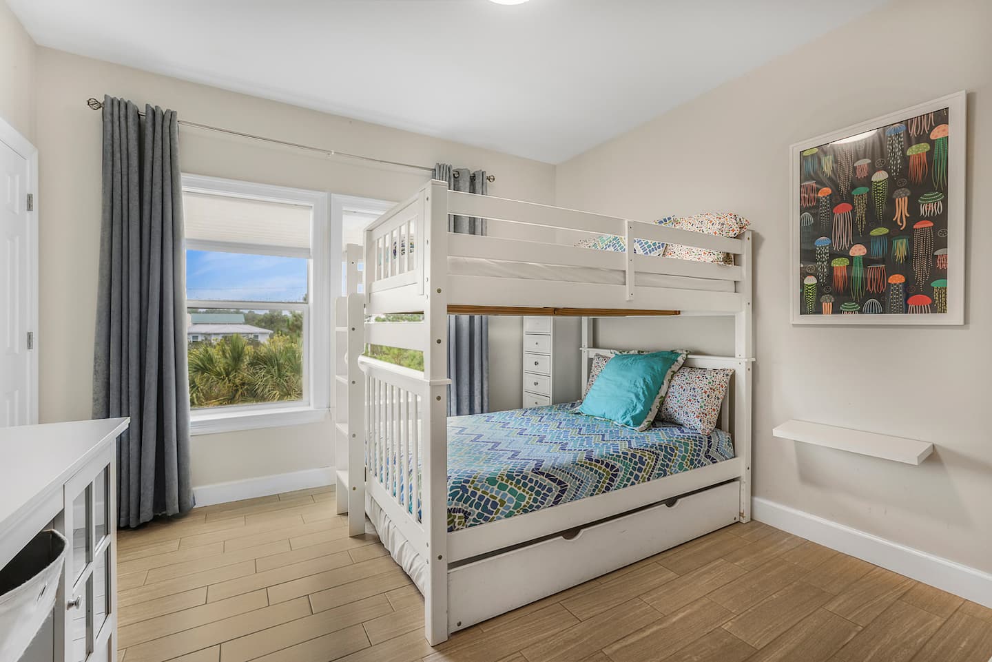 Send the kids up the ladder and pull out the trundle for one more: three beds in one room means the grown-ups get the quiet floors. Sleeps 10 without anyone on a couch.