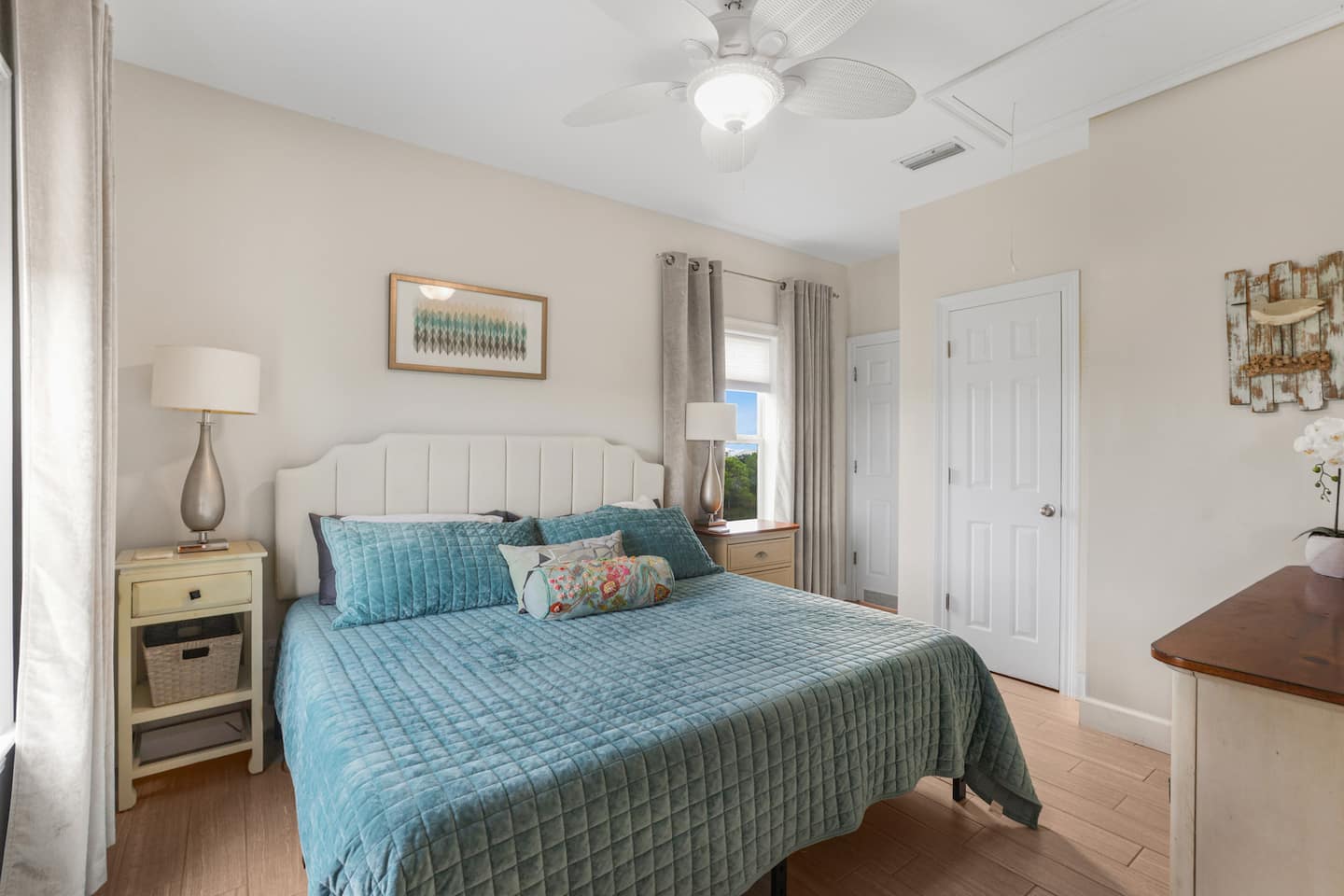 Close the door and the house noise disappears: the primary suite sits apart from the chaos, with the private bath right through the door.