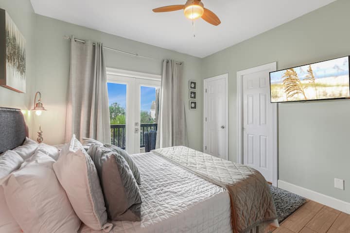 Keep the curtains open and let the porch be part of the room: your own TV, closet space, and the outside a step away.
