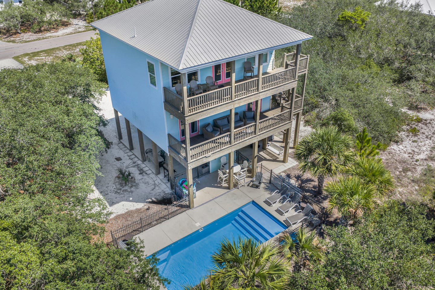 Pick your porch: three levels of covered deck stacked over the pool, so you always have a shady spot whichever way the wind blows.