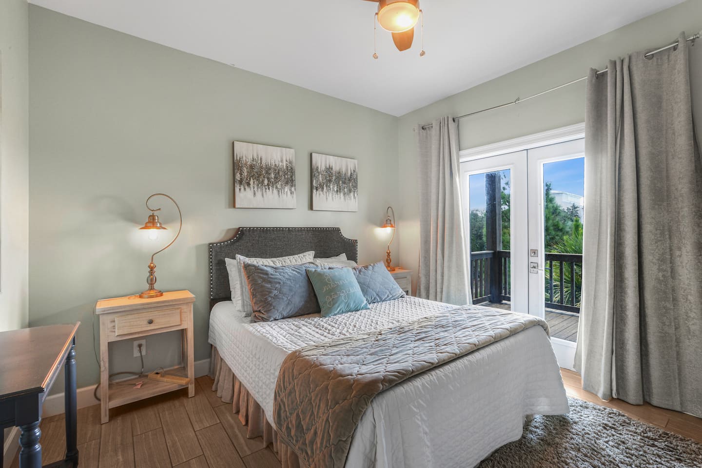 Roll out of bed and onto the deck: French doors, a desk if you need to check in with work, and lamps on both sides for late reading.