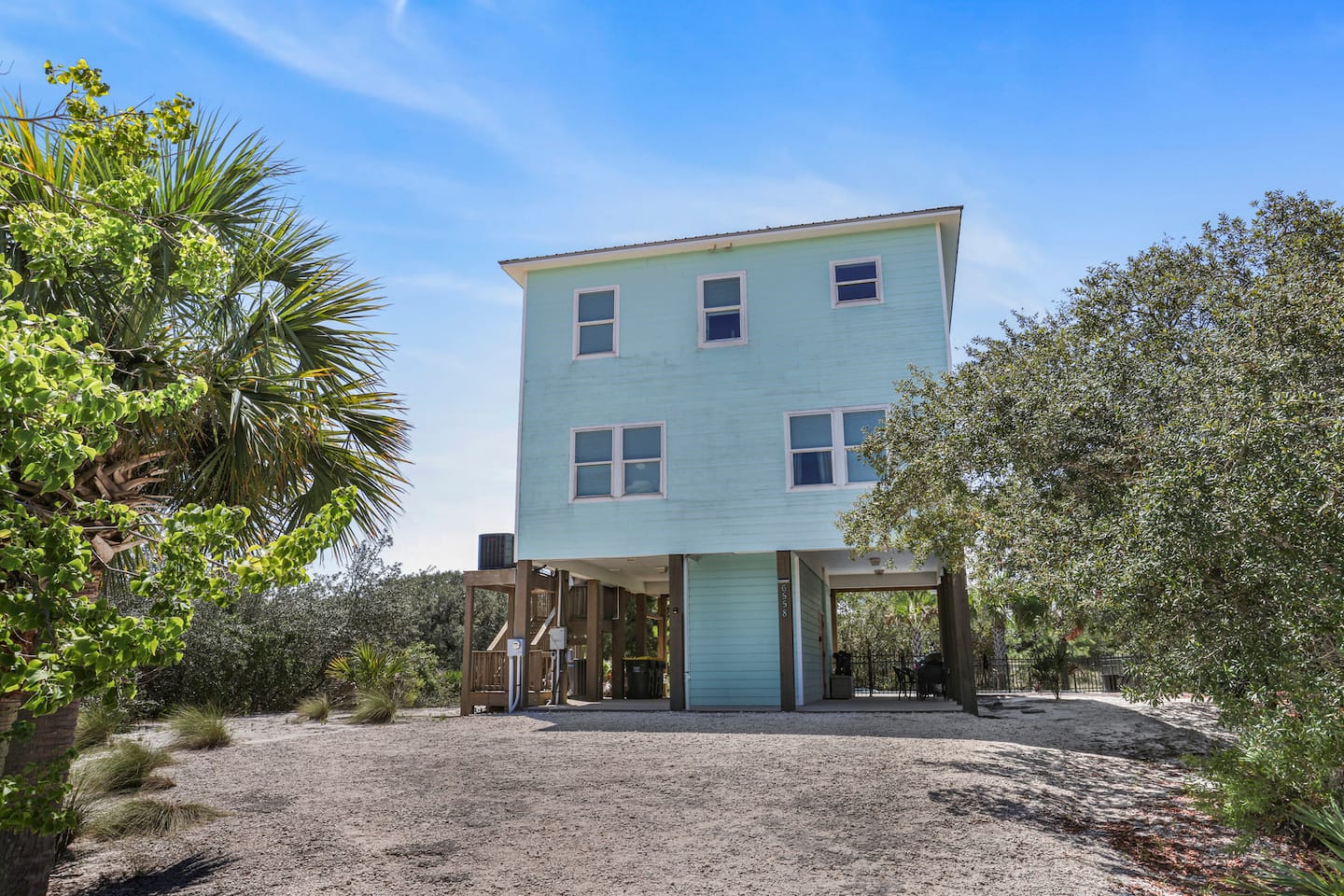Park in the shade under the house and haul the beach gear straight to the outdoor shower: the whole ground floor is built for sandy feet.