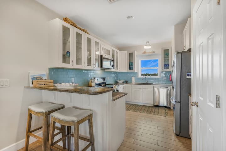 Pull up a stool at the bar and keep the cook company: coffee in the morning, drinks before dinner, the whole kitchen open to the rest of the house.