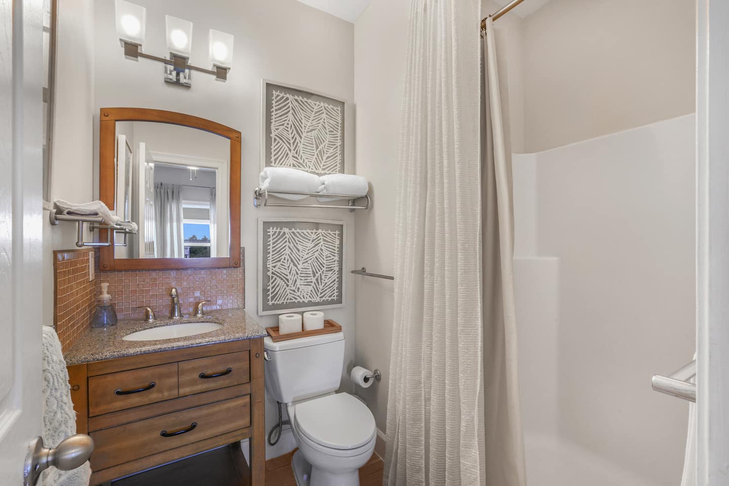Take a long soak after the beach: a full shower with towels stacked and ready, steps from the guest rooms.