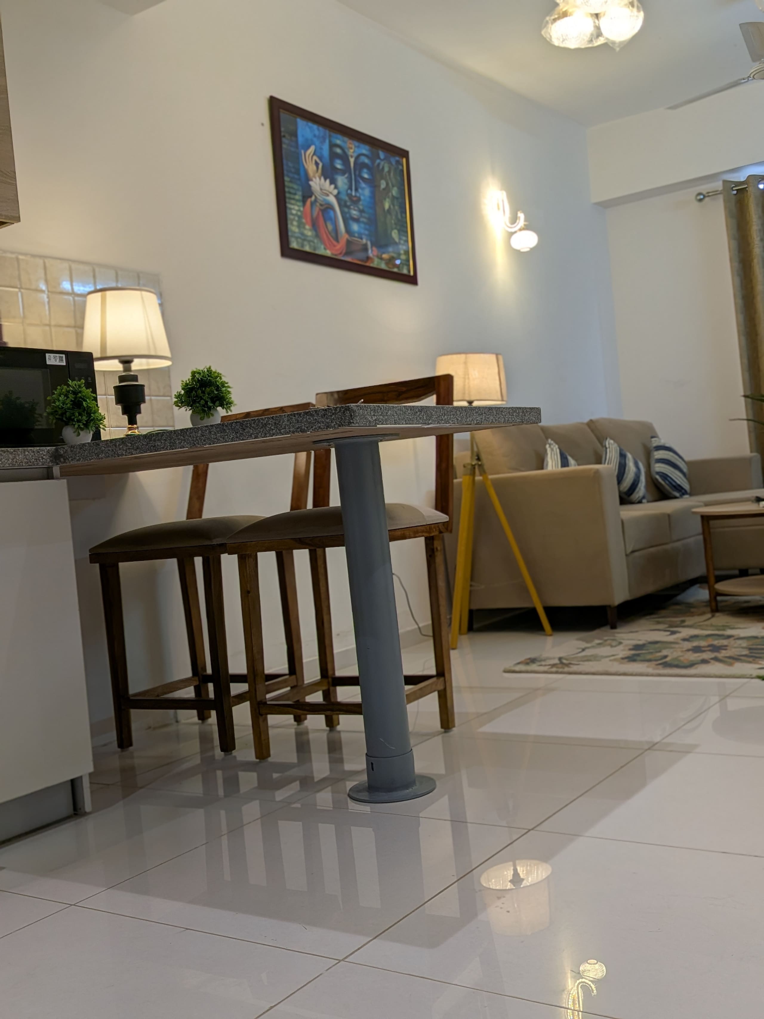 Breakfast bar with high stools and a colourful painting
