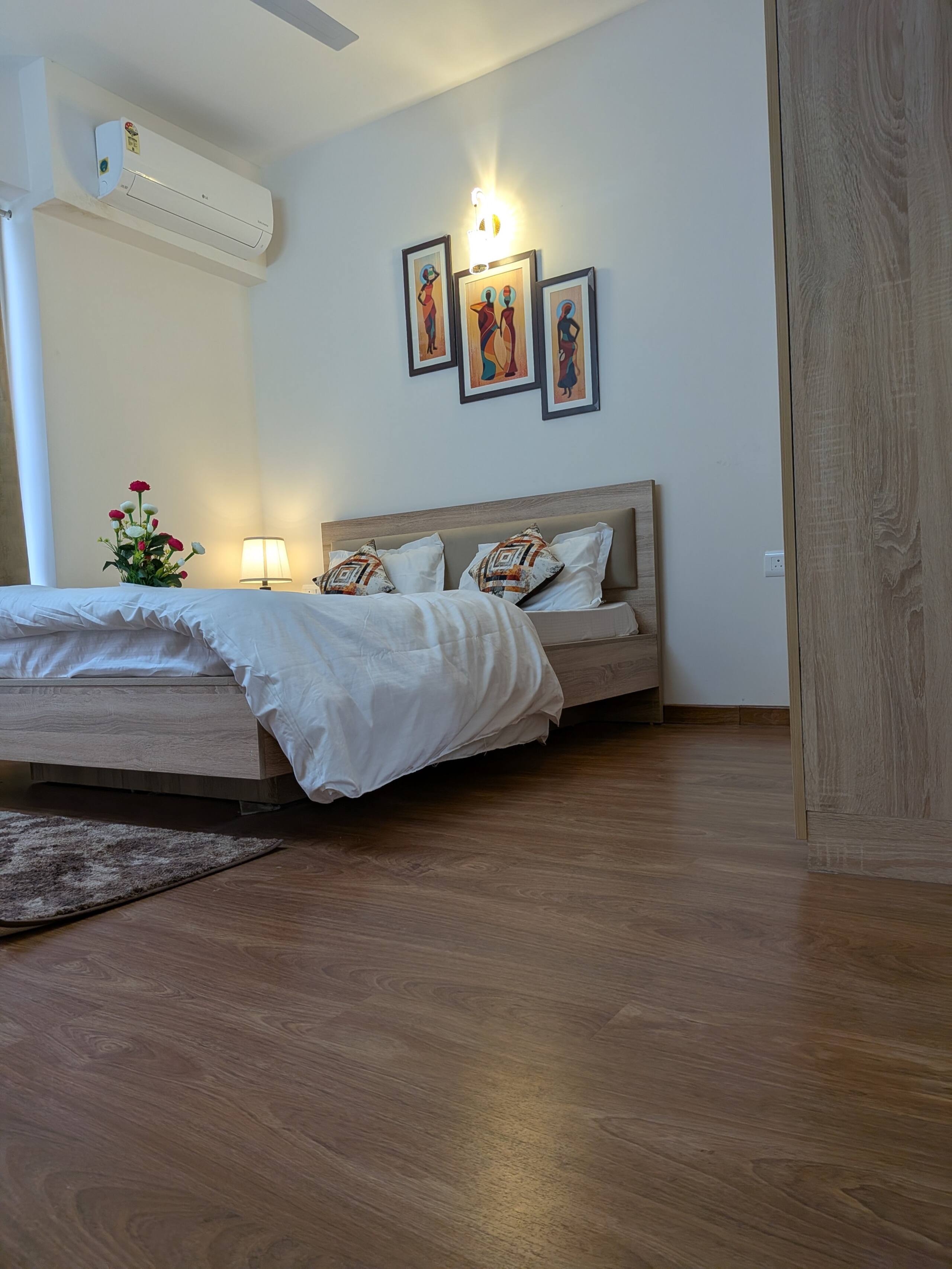 Bedroom two with framed art and a rug
