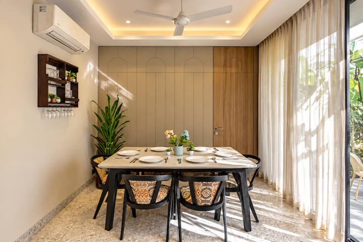 **Dine, Unwind & Stay Awhile **

A bright, cozy dining space opening straight into the garden, with a mini bar unit right beside you for added convenience. Perfect for lazy breakfasts, evening drinks, and long conversations. ✨