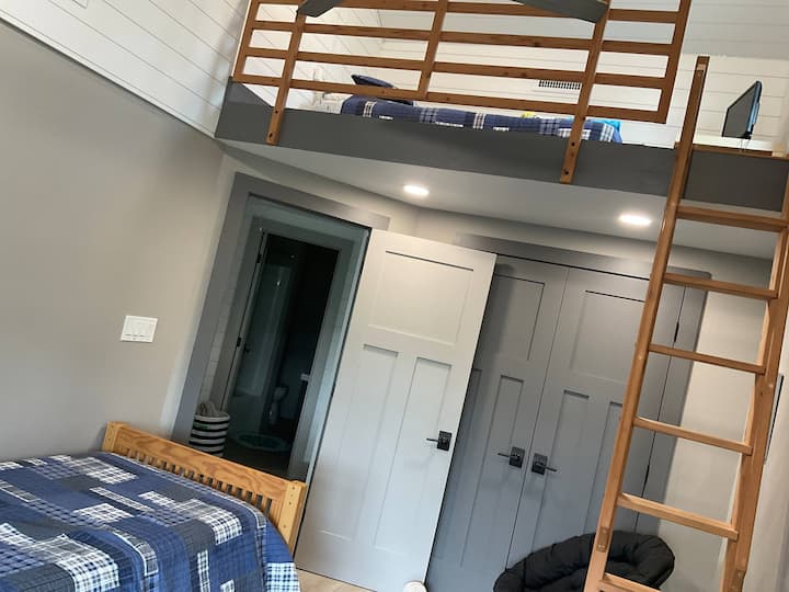 Two twin beds, one on ground level and second in the loft