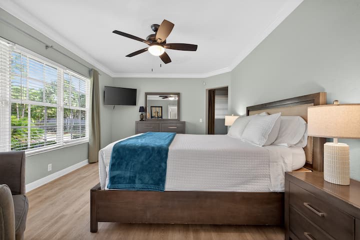Relax in this comfortable primary bedroom featuring a queen bed and private in suite bathroom.