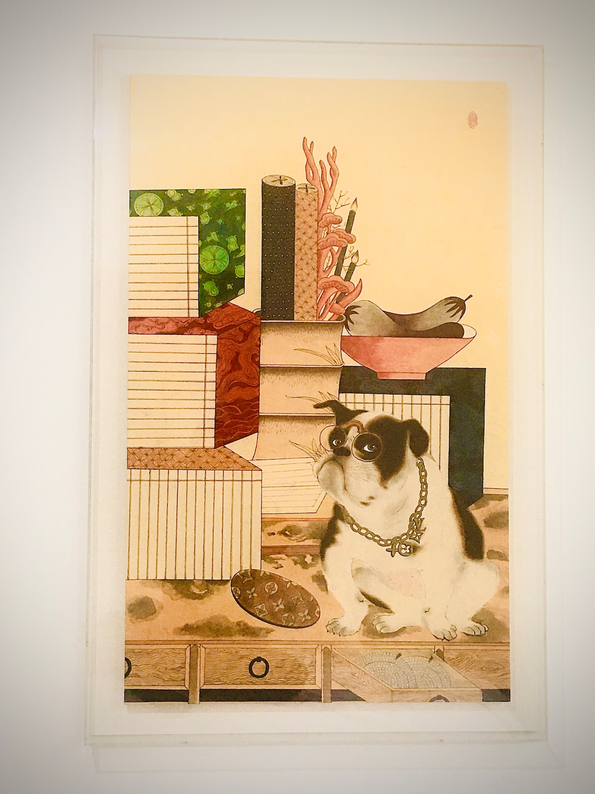 An art piece features a seated dog adorned with a necklace, positioned in front of various patterned boxes. The background includes a bird atop a stack and decorative elements, showcasing a blend of colors, textures, and cultural motifs.