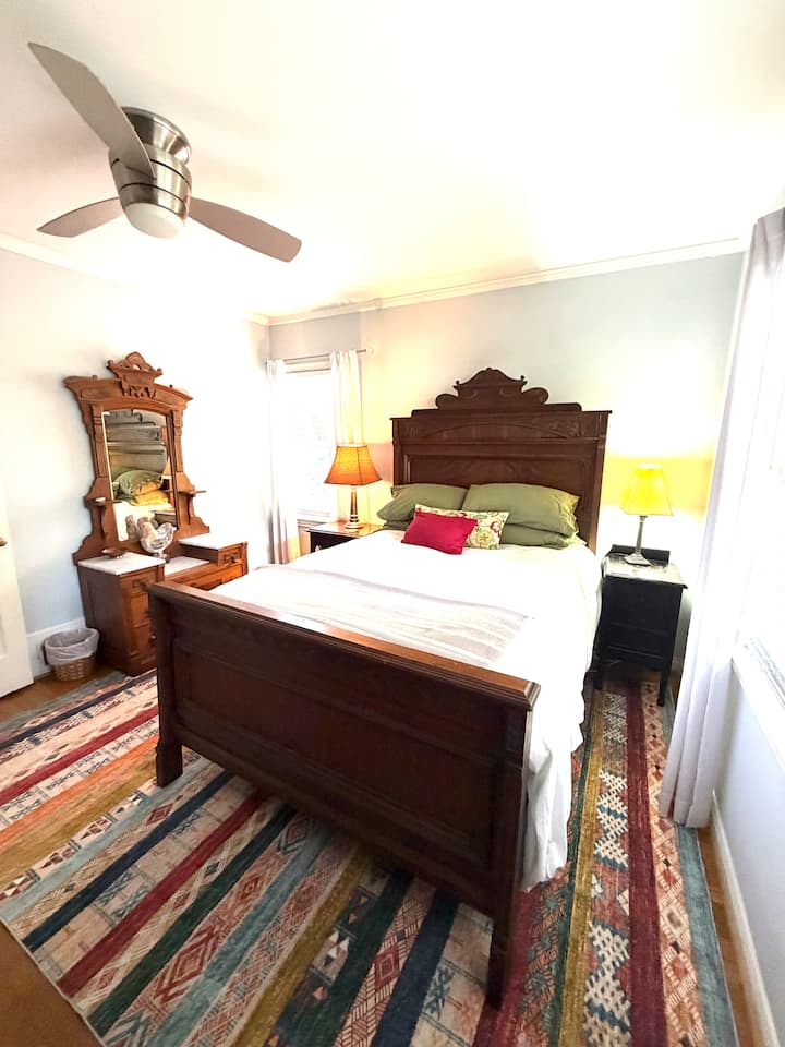 Our beautiful full sized walnut Victorian bed has an 1890s dresser and shabby chic end tables and a view of the animals.