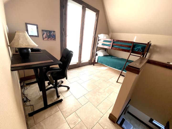 Potkrovlje s krevetima na kat i uredskim radnim prostorom.  Nalazi se iznad apartmana s bračnim krevetom.