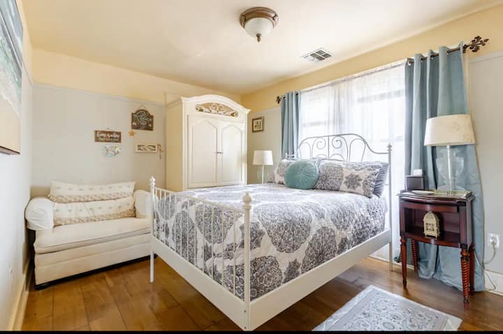 Comfortable Bedroom decorated in Beige & Blue. 
Relaxing vive. 
Hardwood Floors