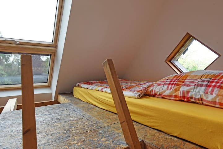 Kitanda kwenye dari kinaweza kufikiwa kupitia ngazi yenye mwinuko mkali. Mwonekano mzuri wa mashambani