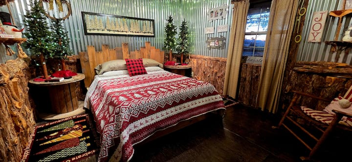 The guest bedroom has a Queen sized memory foam bed and two giant spindles as night stands.  Wake up to thousands of Christmas Trees growing just outside the window.