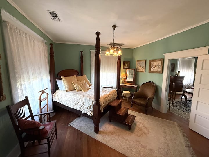 The second bedroom features a full-size antique bed and access to a private bathroom.