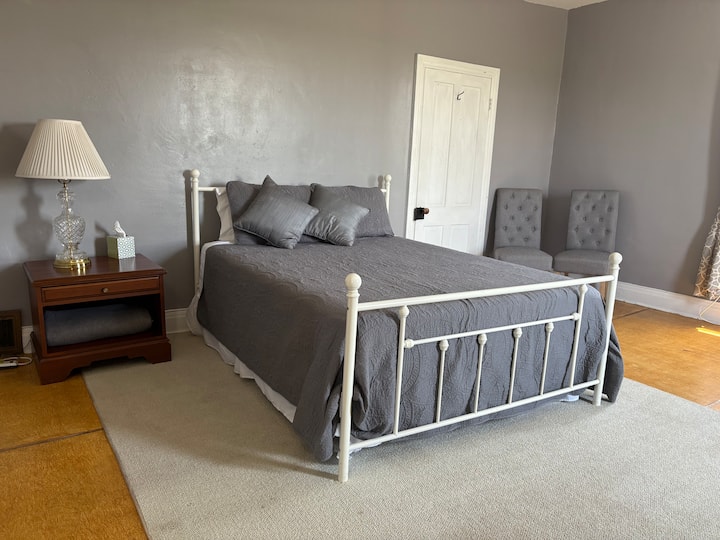 Bedroom #3: Large room with queen-size bed, desk, night stand and luggage rack.