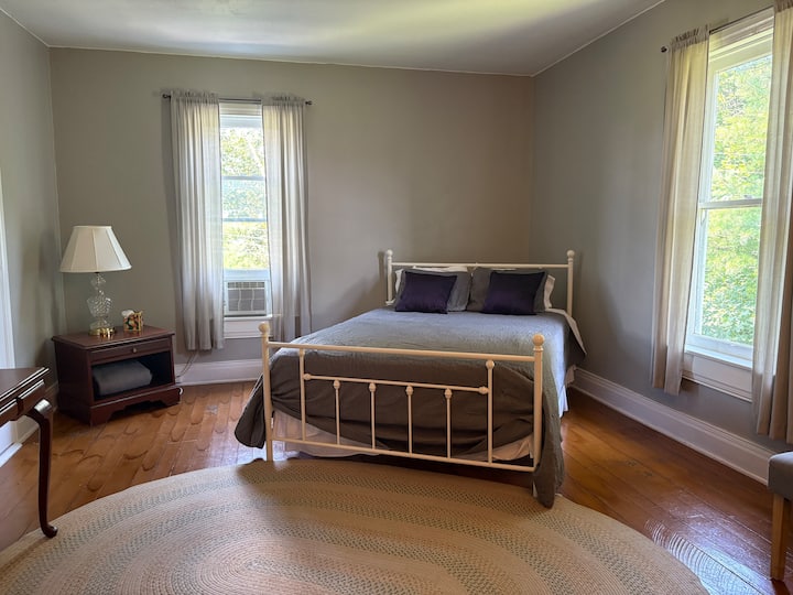 Bedroom #4: Large room with queen-size bed, desk, night stand and luggage rack.