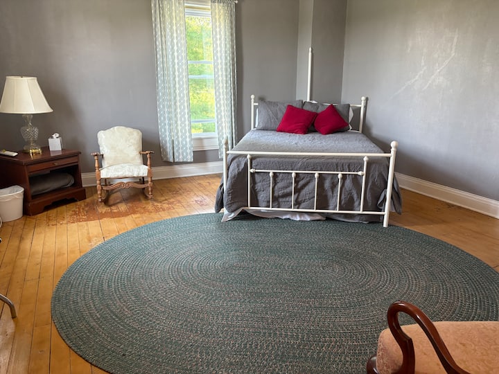 Bedroom #2: Large room with queen-size bed, desk, night stand and luggage rack.