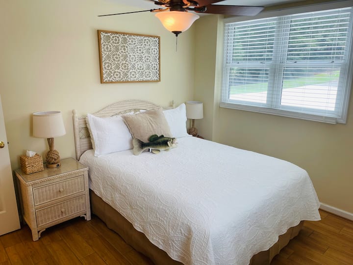 Bedroom 2 on first floor with queen bed & space for clothes.  Lakeview.  Ceiling fan. Blinds.