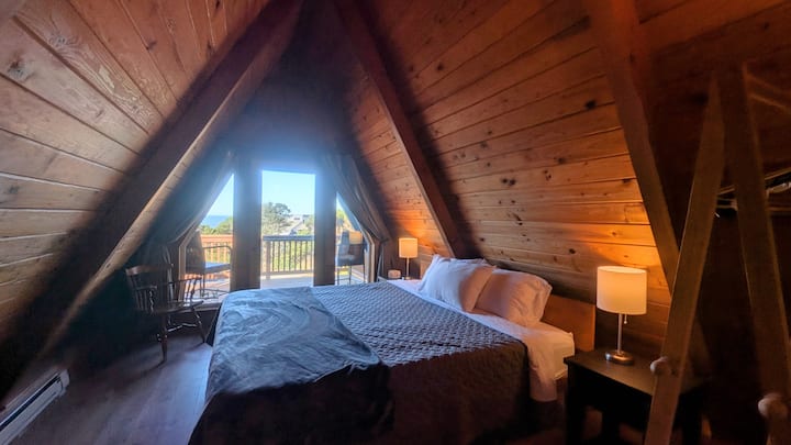 Main bedroom features a king size bed, an ocean view, and a balcony.