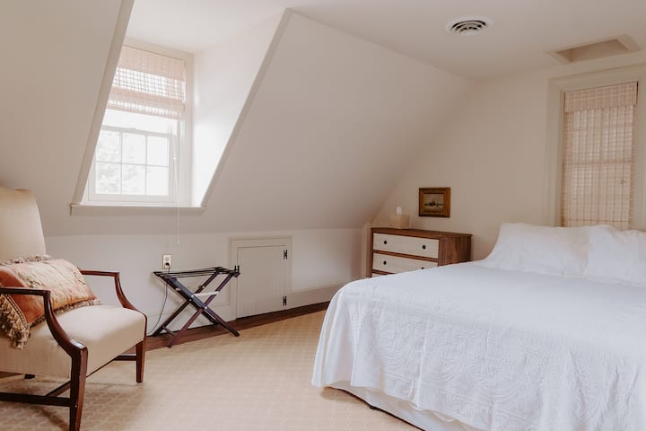 Bedroom with its own flight of stairs.  Full bath is across from stairs and also serves as a powder room as it’s right off family room. Queen bed, river front view. No closet.