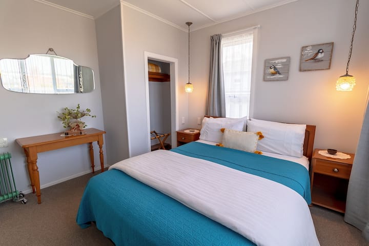 Peaceful master bedroom with quality linens in central Rotorua accommodation
Double-glazed windows 
Luggage rack and hangers