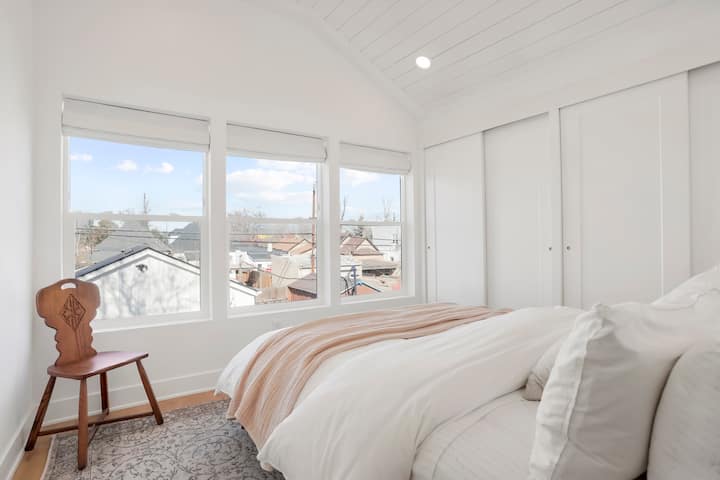 Down the hall, discover another bedroom adorned with a queen-size bed and large windows offering picturesque views of the beautiful backyard.