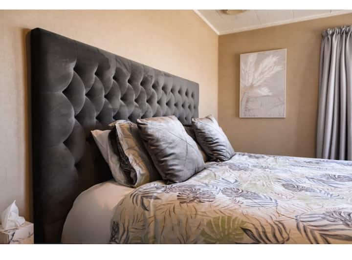 Top quality super king size bed with quality linens, extra pillows and blankets, 55" smart tv, heater, fan and double closet.