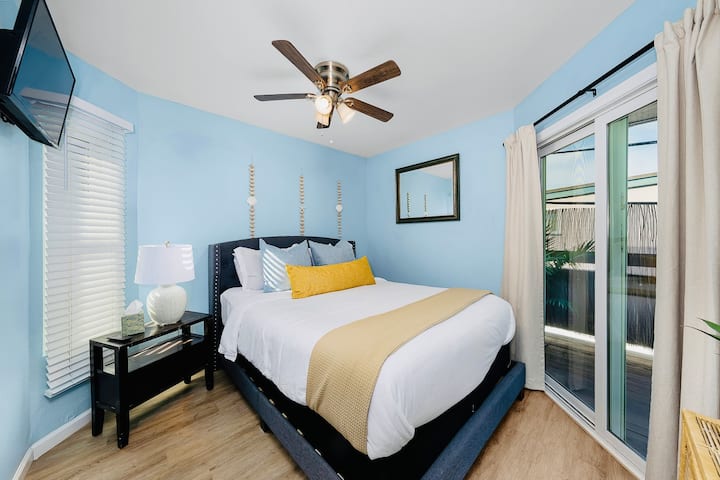 Enjoy this Spacious Coastal Bedroom with Access to a Private Patio