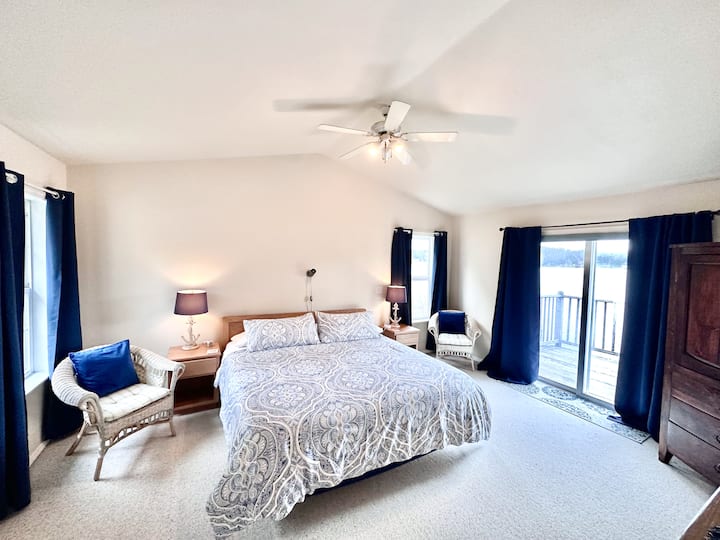Located upstairs

Primary bedroom with private full bath, TV, balcony, and lake views!