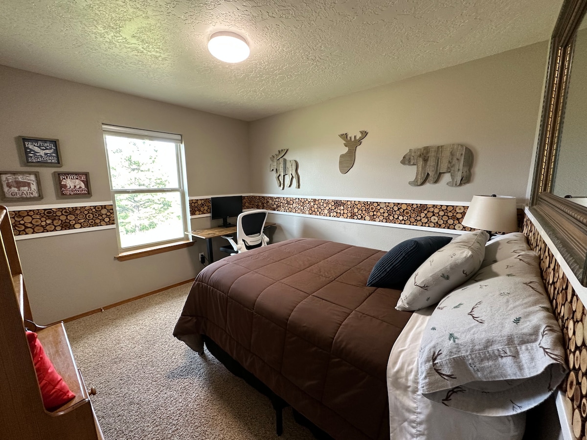 Bedroom 3 is equipped with a full bed, TV with Roku, and a second workspace/desk with comfortable chair. Grazing elk/deer/wild turkey are not an uncommon sight out this window.