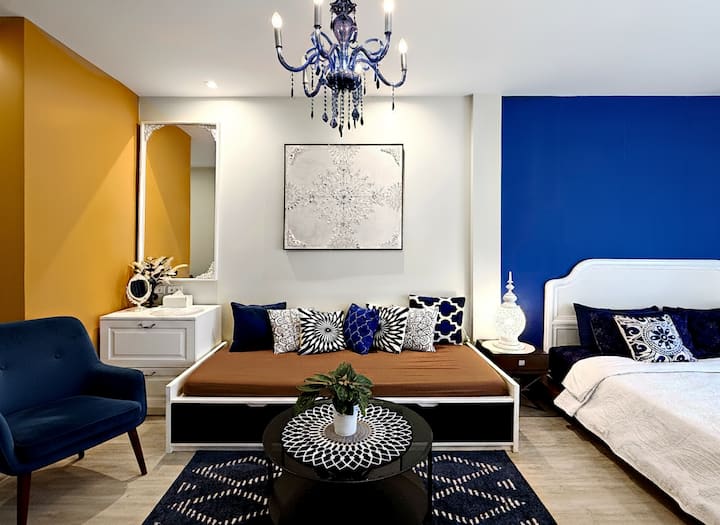Relax in our Master Art Suite featuring stunning abstract gold art, a plush double bed with premium linens, and a cozy reading nook. Your perfectly curated retreat.