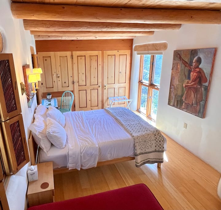 Loveseat, queen bed, 
hand painted small writing desk, oil paintings. 
Open the windows next to the bed for fresh air and sounds of nature. 
   Choice of 2nd luggage rack or meditation cushion in front of the full length window, w pull down blinds.