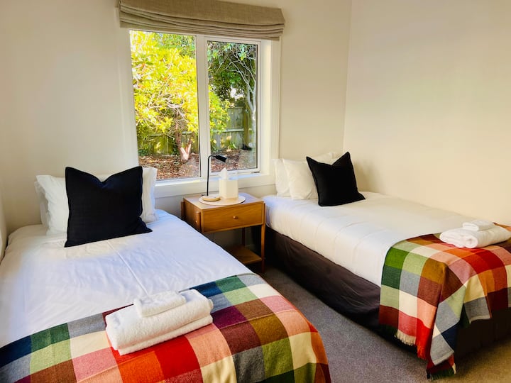 Bathed in natural light,  this comfortable roomy twin room with king single beds has lovely garden views. Wardrobe space for storage.