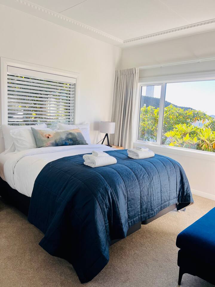 Master bedroom with super comfortable king sized bed. Bed, bedding and pillows all purchased new in 2024. Lovely views towards harbour from this room. Plenty of wardrobe space.