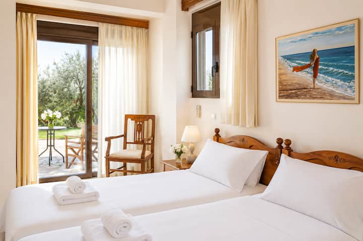 Lower Level - Bedroom 5 with two single beds, ensuite bathroom with shower and direct access to the garden