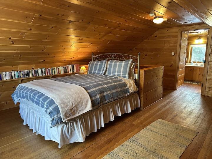 Queen bed. "Take a book, leave a book (not necessary)" library.