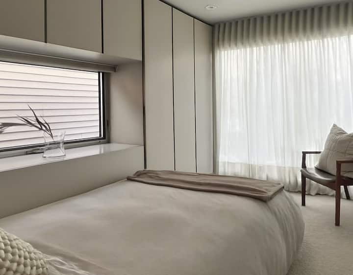 Second bedroom looking towards picture window, cabinets and operable window