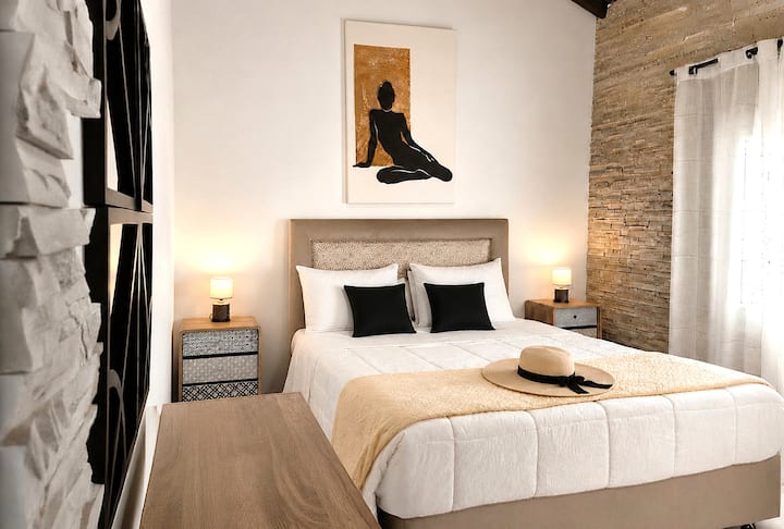The first mezzanine bedroom in the Main Villa features a double bed and an ensuite bathroom