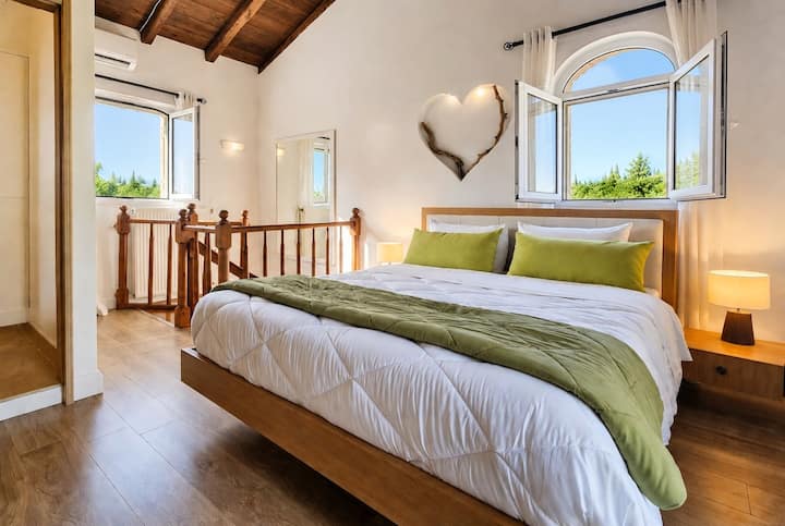 The Main Villa’s second bedroom features a loft-style layout on the top floor with ensuite bathroom and private balcony access