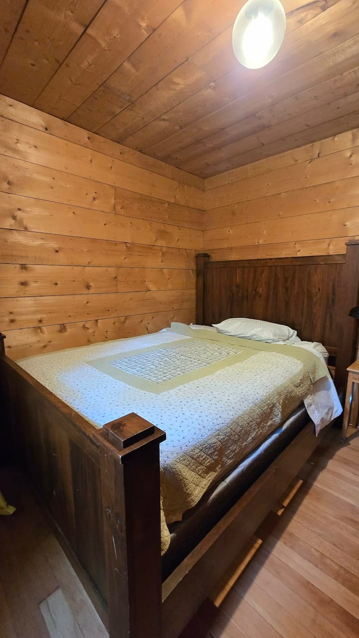 Queen bed in this bedroom. Nicely shaded by the trees surrounding the cottage.