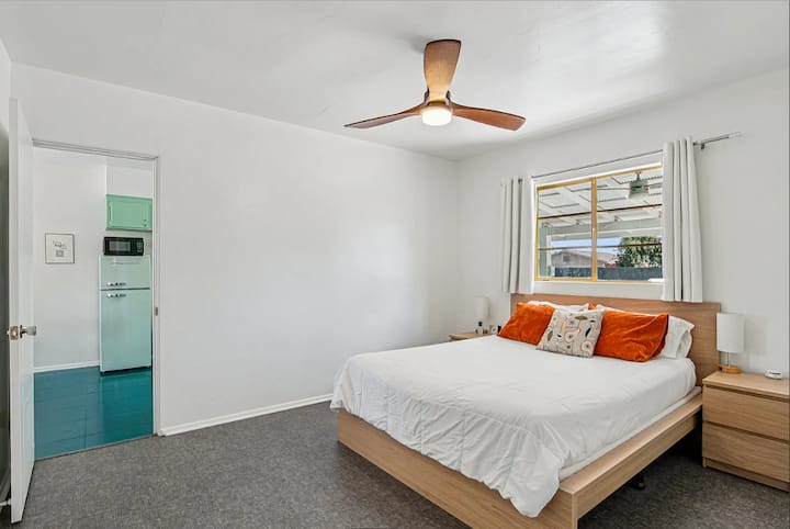 The master bedroom, between the bathroom and kitchen, features a Sleep Number queen bed, USB side lamps, and a closet for your convenience.
