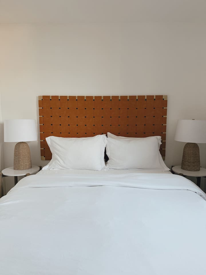 חדר השינה הראשון ממוקם למעלה ומעוצב בקווים נקיים, גוונים ניטרליים ומרקמים נעימים. היא כוללת מיטת קווין סייז, טלוויזיה חכמה ושידה. בארון יש לול קמפינג - מושלם למשפחות שבדרכים.