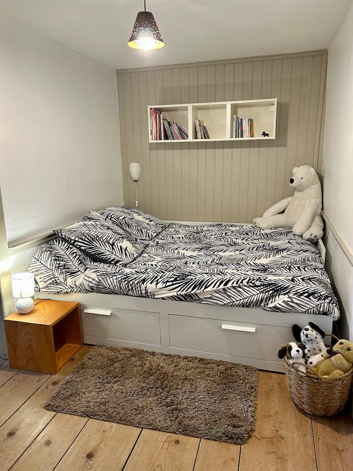 IKEA ‑ ს პატარა საწოლი, რომელიც გადაშენებულია ორადგილიან საწოლში.