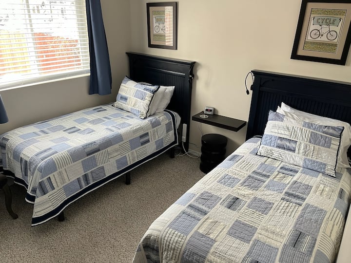 غرفة نوم في الطابق السفلي (الطابق الأول) بسريرين متماثلين وستائر تعتيم وتلفزيون روكو