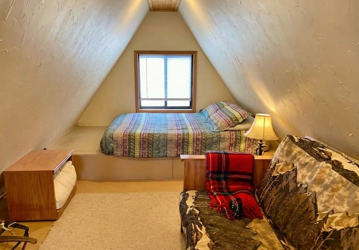 Upstairs loft with a built-in queen bed and futon. Great extra space for reading or taking an afternoon nap!